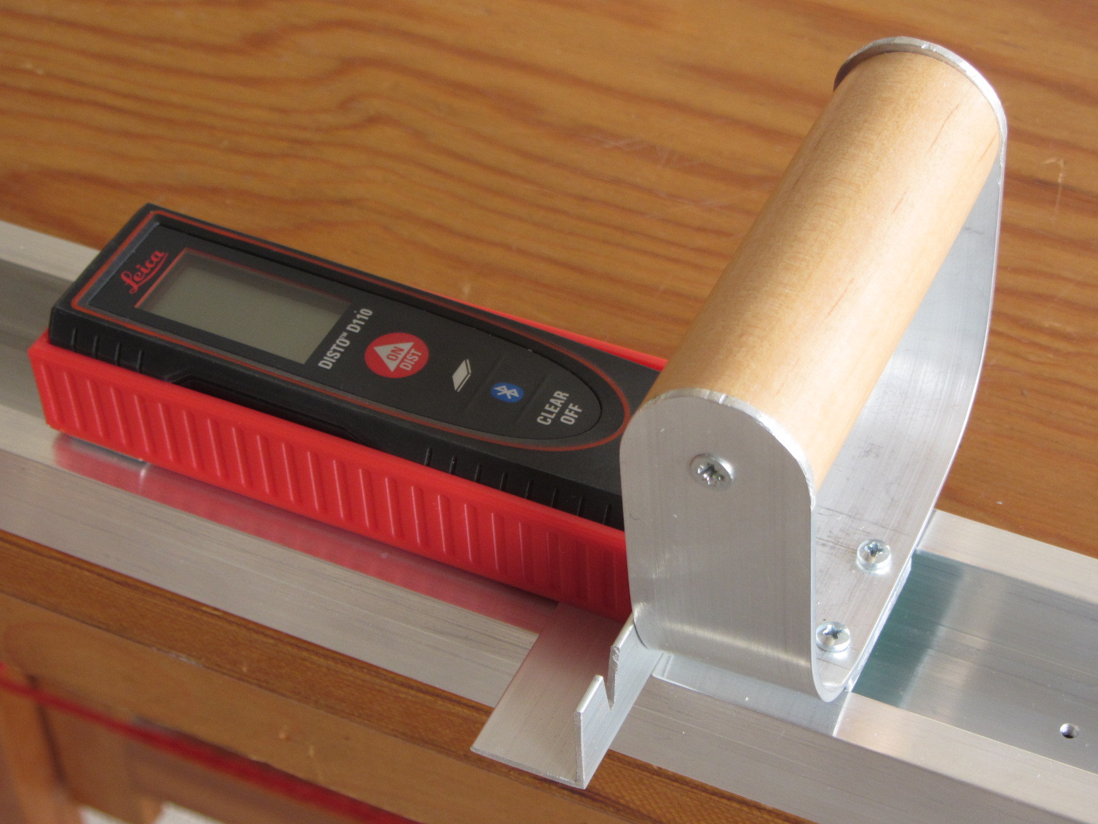 Laser meter in cage on ruler